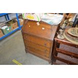 An oak bureau fitted three long drawers