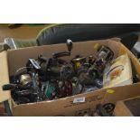 A box of various fishing reels