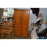 A modern pine wardrobe fitted four drawers