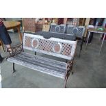 A wooden and metal garden table with matching pair