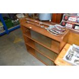 An oak bookcase with glass sliding doors