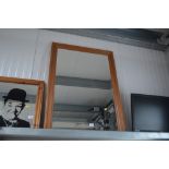 A bevelled edge oblong wall mirror