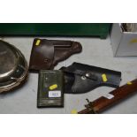 Two gun holsters and a German WW2 gun cleaning tin