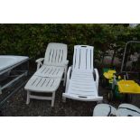 Two plastic garden loungers