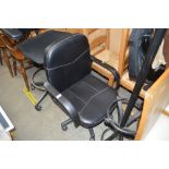 A leatherette upholstered swivel office chair