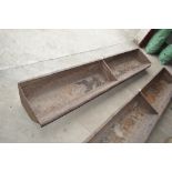 A heavy 8ft cast iron two section feed trough