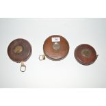 Three leather cased surveyors tapes