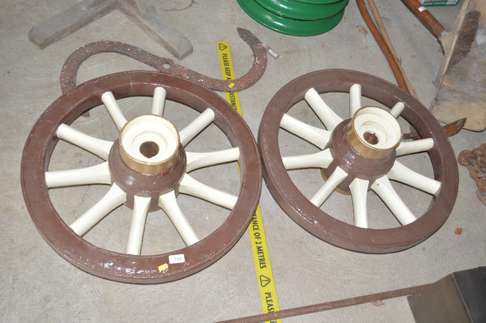 A pair of painted cart wheels