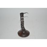 An old twist candlestick on wooden base