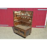 A wooden shop corner cabinet on cast iron wheels w