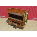 A Vintage wooden trolley cart with metal shelf