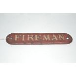 A cast iron "Fireman" plaque