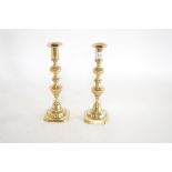 A pair of 19th Century brass candlesticks with eje