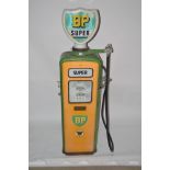 A Vintage petrol pump, decorated in green and yell