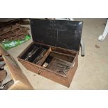 An old metal toolbox and contents, including calip