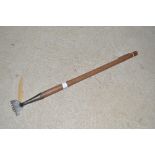 A Vintage carpet stretcher with elm handle