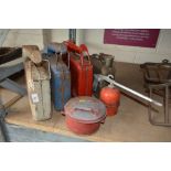 Four Vintage petrol cans; an oil can and a Safety