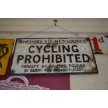 A cast metal sign "Cycling Prohibited, Cheshire Cou