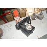 An old Bakelite telephone, and a trim phone