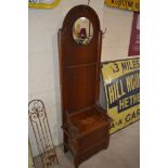 A 1930's oak hall seat/stick stand