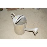 An unusual shaped metal watering can with square r