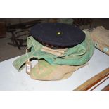 A regimental beret; a hessian sack; two green canv