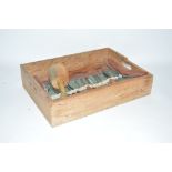 A wooden tray containing carving chisels, mallet a