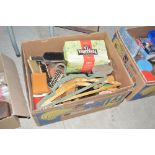 A box of various old brushes, coat hangers, shoe p