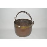 A large copper pot with iron swing handle