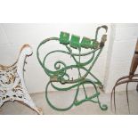 A pair of green painted wrought metal garden bench