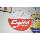 An enamel circular advertising sign for "Capital A