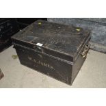 A metal deed box, flanked by carrying handles, mar