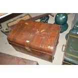 A brown japanned tin trunk