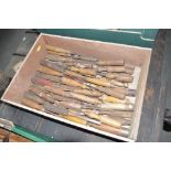 A tray of various old wood chisels