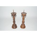 A pair of 19th Century oak pricket candlesticks