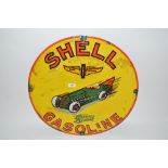 A circular enamel advertising sign for "Shell Gaso