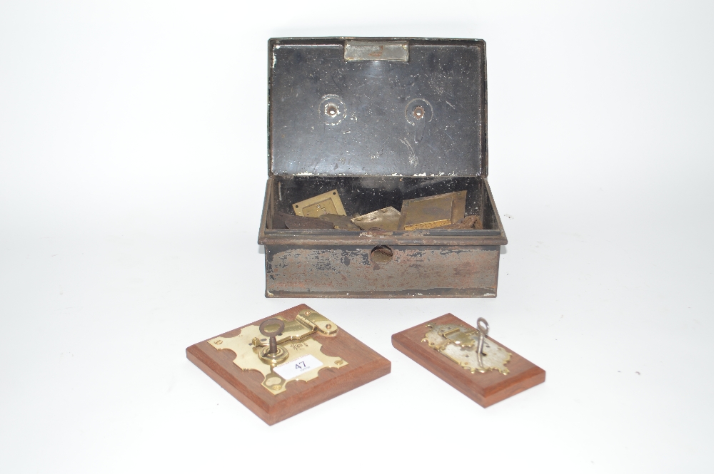 A tin box containing Vintage trunk locks and two e