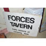 A metal road sign painted "Forces Tavern, Cars Par