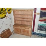An Antique rustic pine dresser, having shelved and