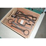 A wooden tray box containing various cart spanners