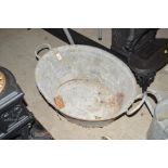 A small oval galvanised bath