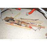 Three wood clamps, four saws, a camp bed and two b