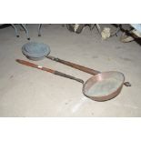 An Antique copper warming pan with turned wooden h