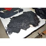 A black lace wrap; an ostrich feather type fringe