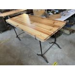 A pine trestle table with period cast iron support