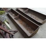 A heavy 8ft cast iron two section feed trough