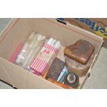 A box containing various old candles and wax etc.