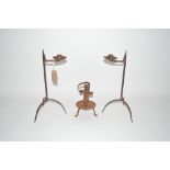 A pair of iron candle holders and a wrought iron s