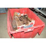 A box containing various axe heads, weights, shear