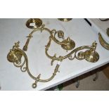 Three brass Braze patent wall lights with scrolle